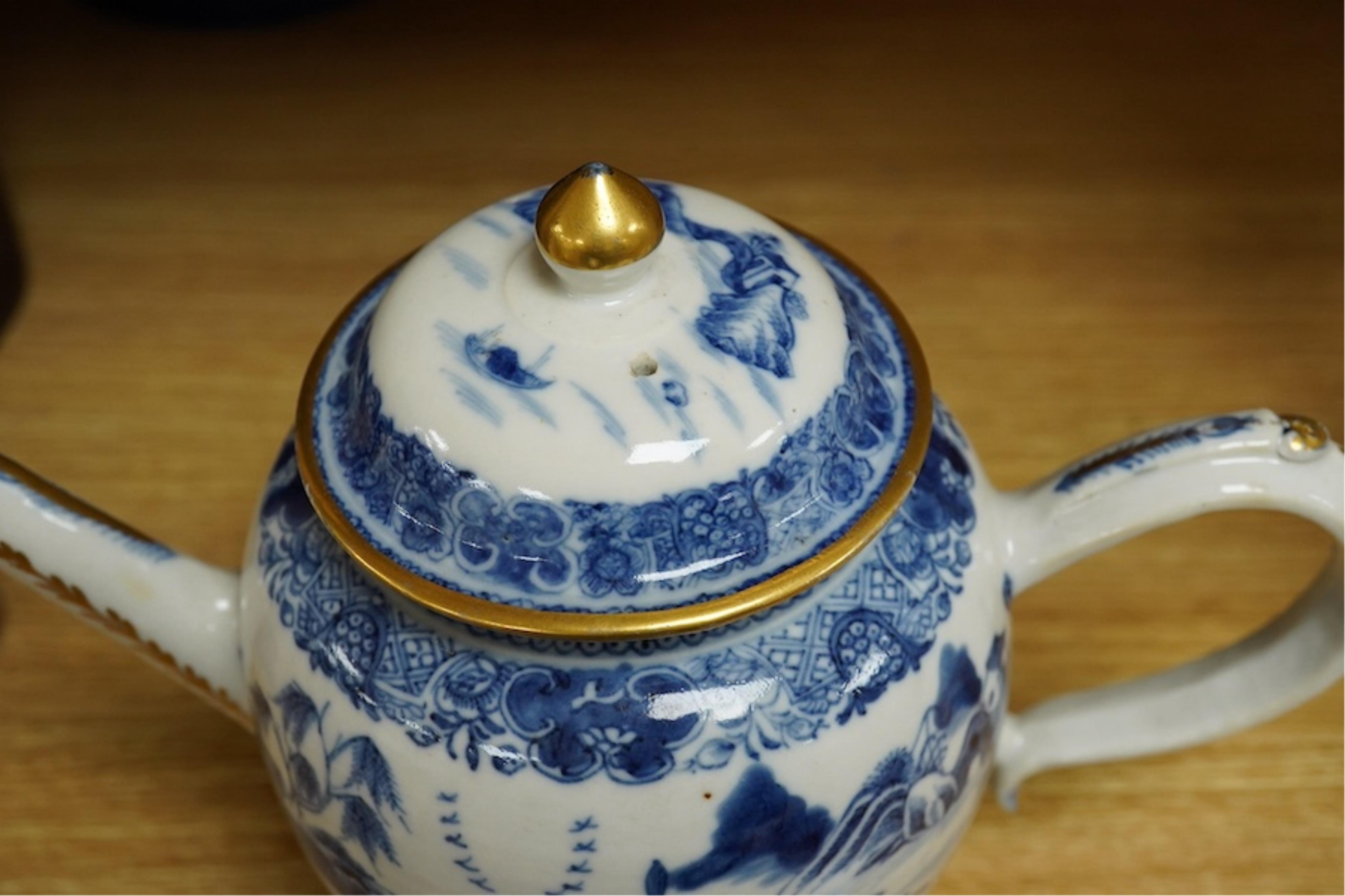 A Chinese export blue and white teapot, c.1790, painted with pagodas, 24cm wide. Condition - some chipping and firing cracks